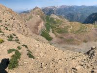 View of Timpanogos Basin with the red American Fork Twin Peaks visible in the upper center of the photo.